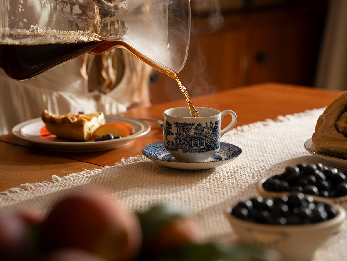 coffee and a slice of pie and some berries